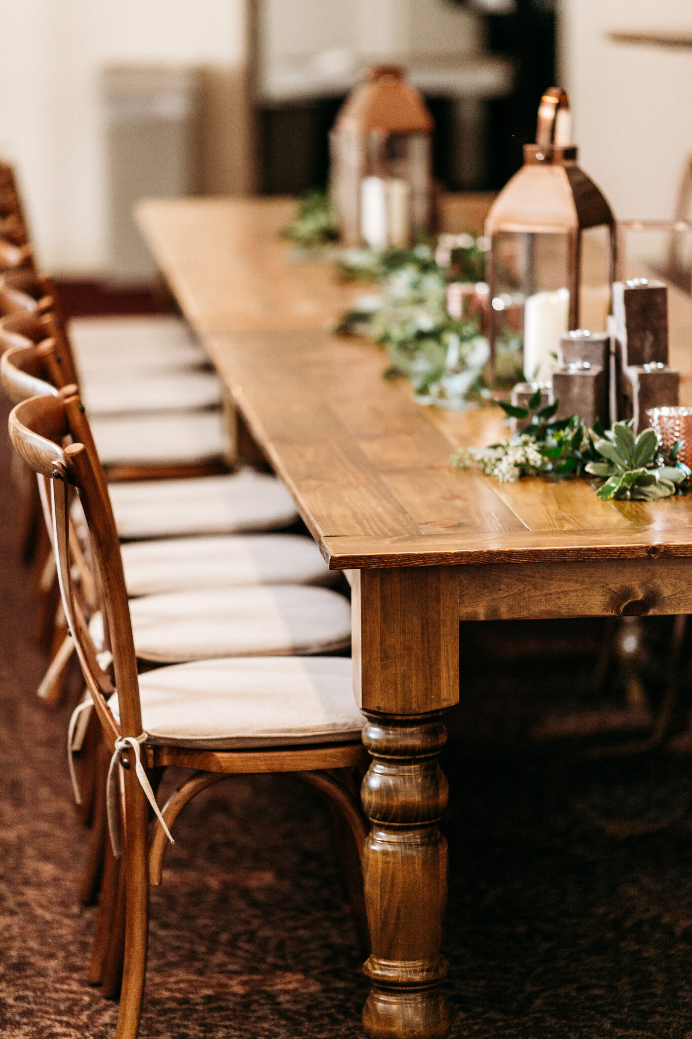 Wooden dinning chairs with a flat white chair cushion 