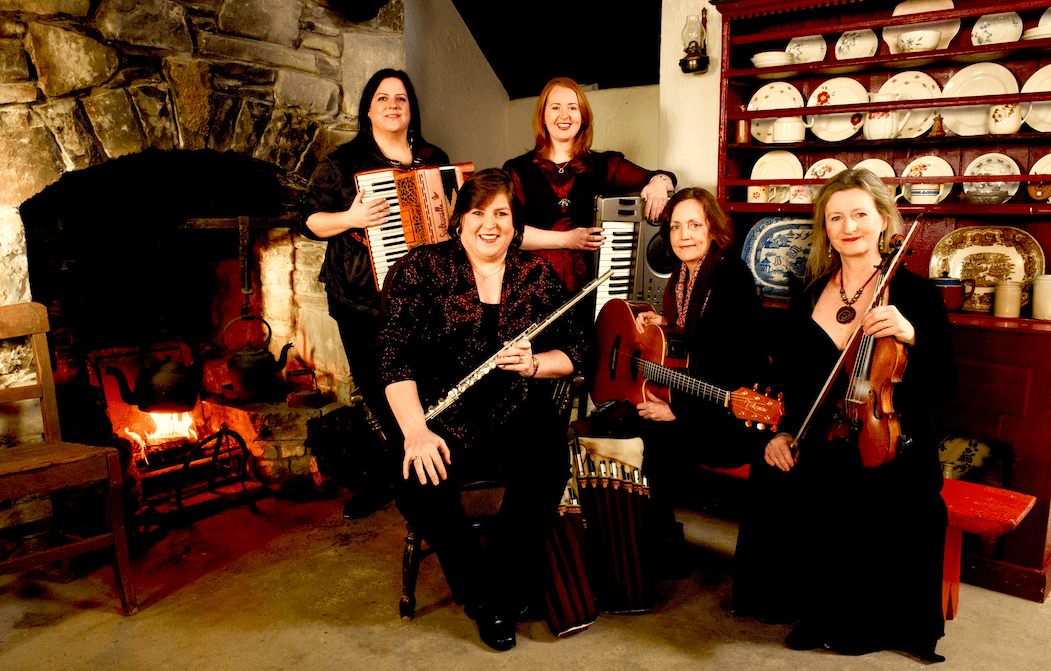 Five women holding music instruments