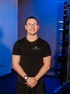 Man smiling in a gym setting.